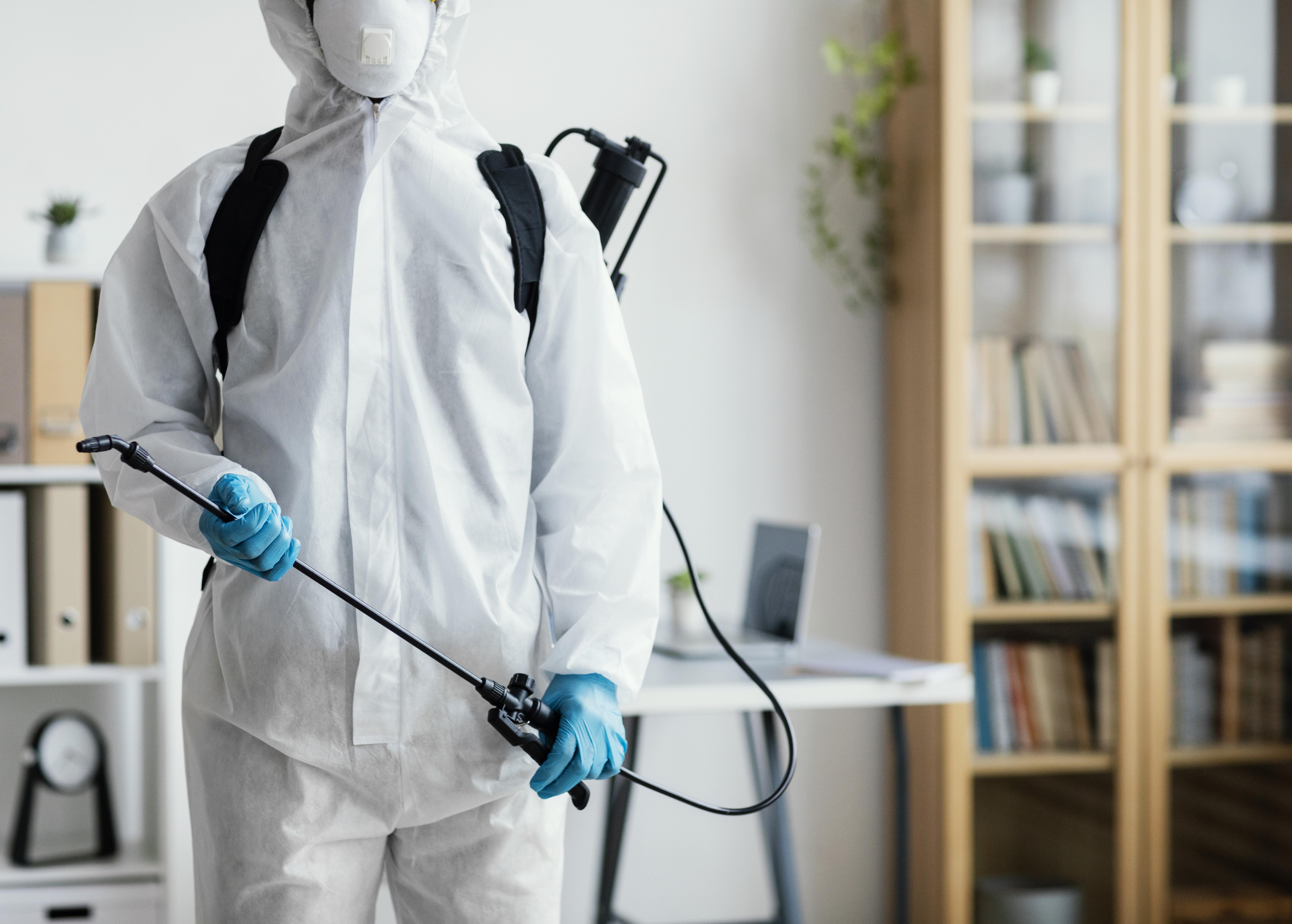 Pest control professional with sprayer equipment